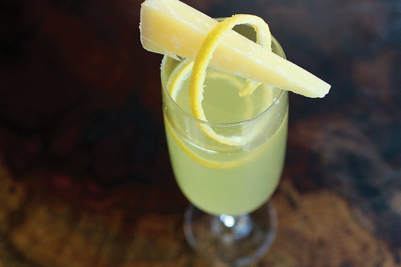Cheese makes a dramatic statement atop a cocktail at Emmer & Rye in Austin, Texas. The Genepy Fizz is topped with a garnish of Switzerland’s Glarner Alpkäse cheese.