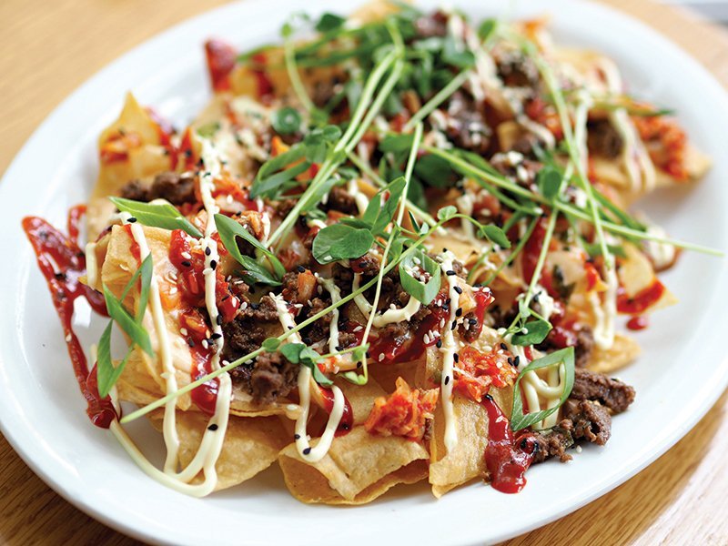 Cheese can now accompany Asian flavors with ease. Pepper Jack cheese sauce merges with bulgogi and gochujang on these Korean-Style Nachos at Graze in Madison, Wis.