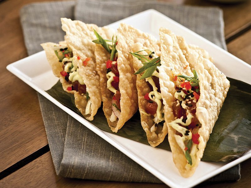 Seafood appetizers are a natural offering for island-themed Tommy Bahama. Ahi tuna tacos stand out with Asian slaw and wasabi-lime- avocado sauce.