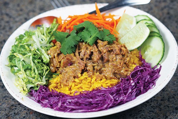 When smothered in savory sauce, green jackfruit truly impersonates meat in texture and flavor. Here, it subs nicely in a vegan pork Thai green curry bowl.