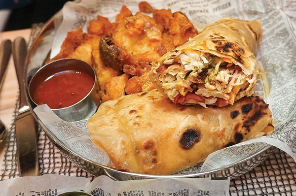 At Sambar in Los Angeles, creative kati rolls include this British Raj Chicken with pomegranate-peach chutney, as well as a loaded vegetarian kati roll.
