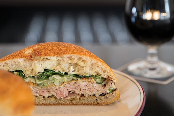 To prevent flavor fatigue, indulgent pork shoulder is complemented by minty cucumber crudité in this sandwich offering at Branch Line in Watertown, Mass.