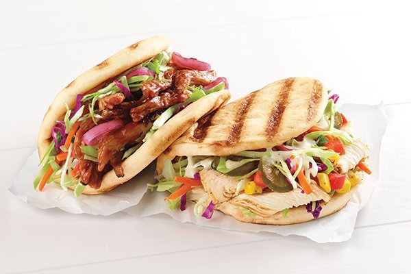 Grilled flatbread sandwiches at Corner Baker Cafe spill over with interesting vegetables, from corn salsa in the Southwest flat to house-pickled jalapeños in the Asian Pork version.
